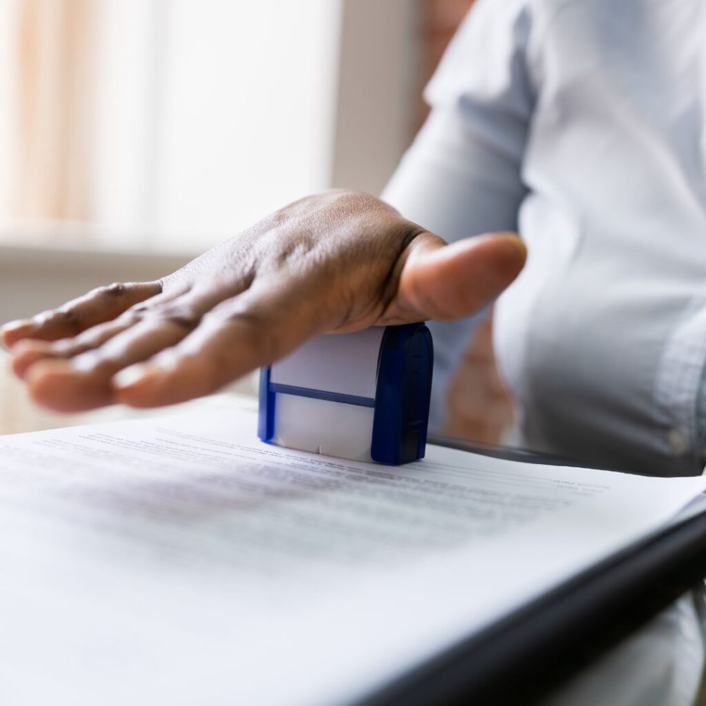 female notary stamping a document